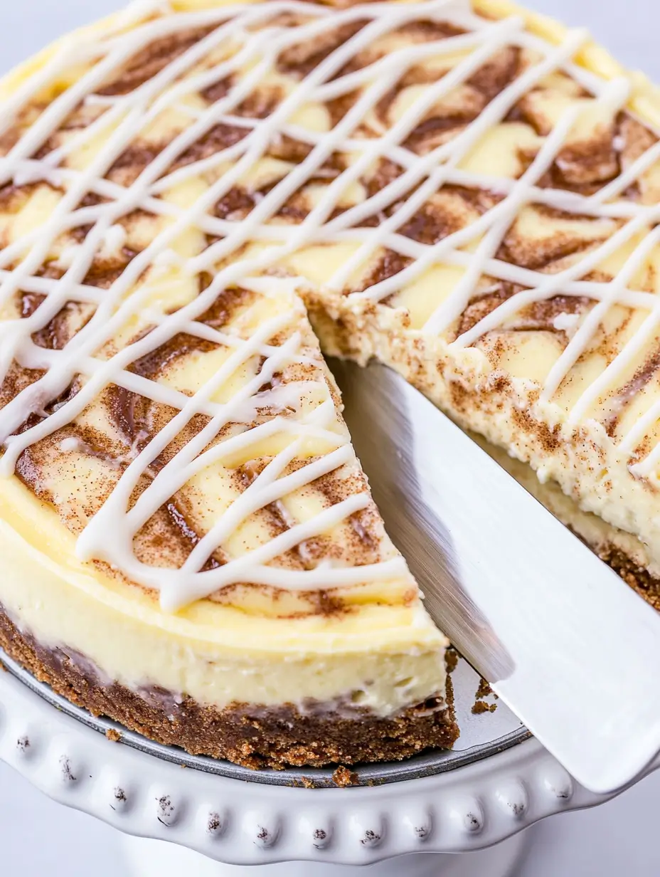 CINNAMON ROLL CHEESECAKE 2 Full-cinnamon-roll-cheesecake-drizzled-with-icing-on-a-pedestal-stand