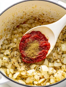 tomato-paste-and-seasoning-added-to-onion-mixture-for-lasagna-soup