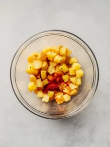 Crispy Air Fryer Breakfast Potatoes 23 Seasoned-Potato-Cubes-in-Clear-Mixing-Bowl