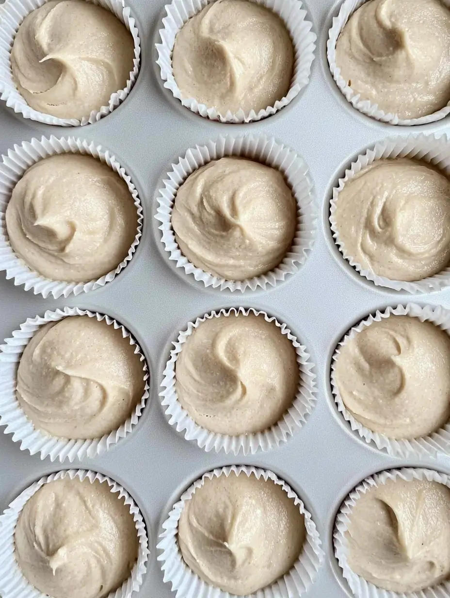 Pistachio and Raspberry Cupcakes Made Simple 14 creamy-cupcake-batter-in-a-muffin-tray-ready-to-bake
