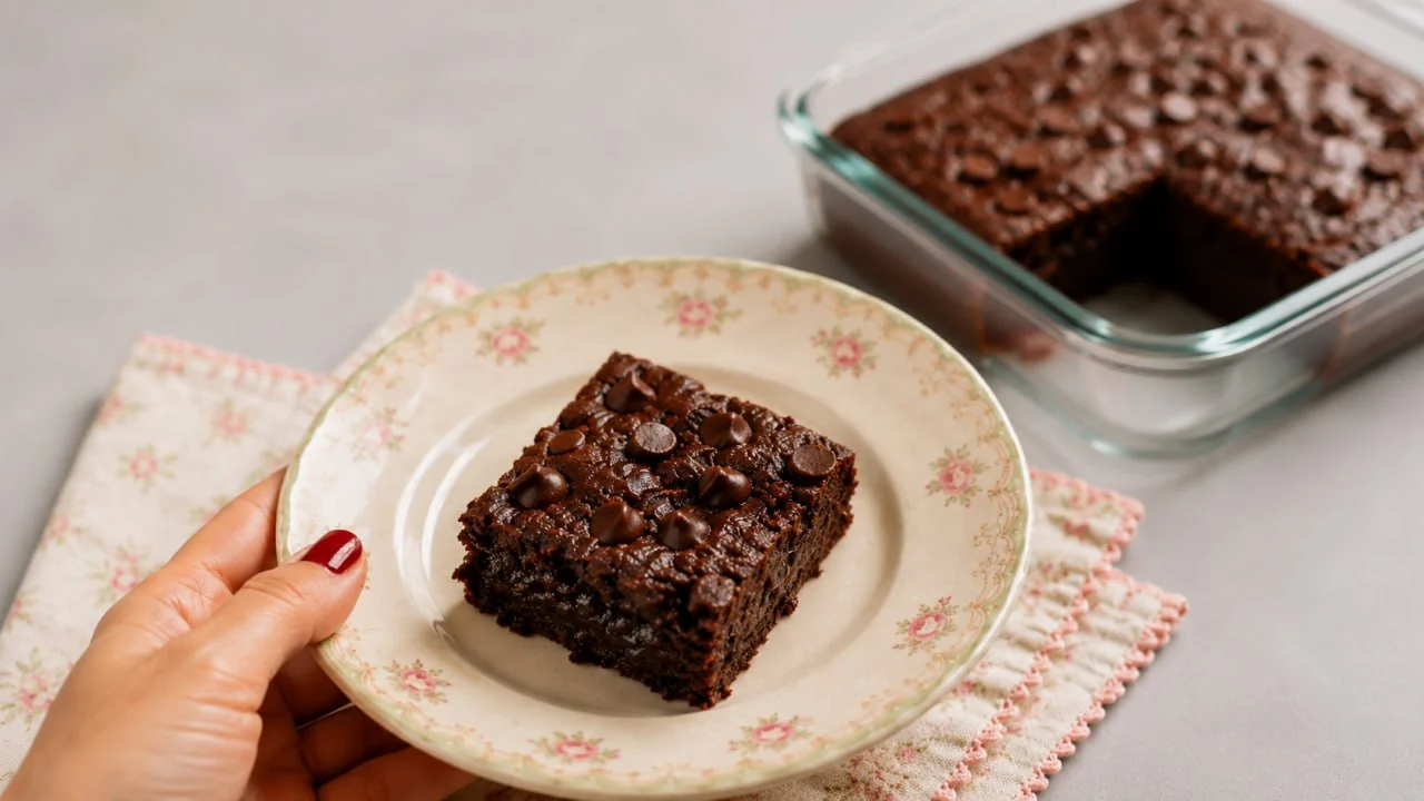 High Protein Fudgy Banana Brownie square on a floral plate with the baking dish in the background