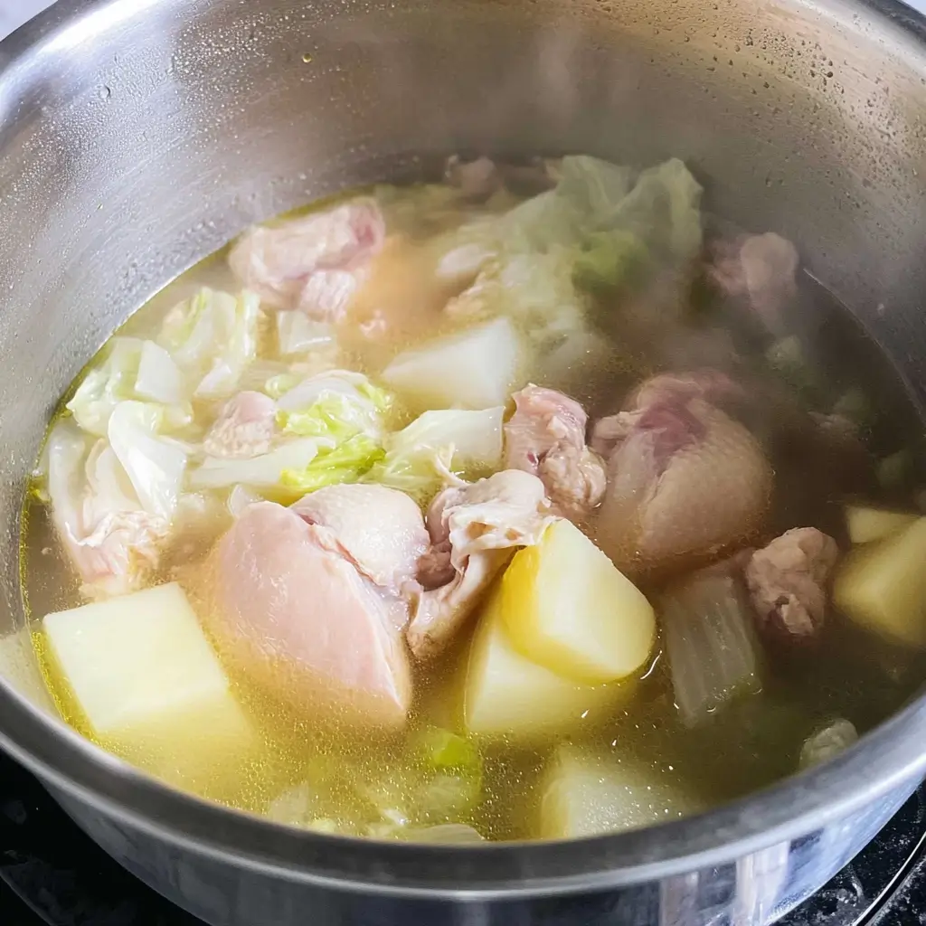 Chicken Cabbage Soup for Quick Fat Burning 43 steaming-soup-with-potatoes-cabbage-and-chicken-in-a-metal-pot