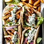 Chicken Pita With Tzatziki 31 pita-wraps-filled-with-grilled-chicken-tzatziki-lettuce-cucumber-and-seasoned-fries
