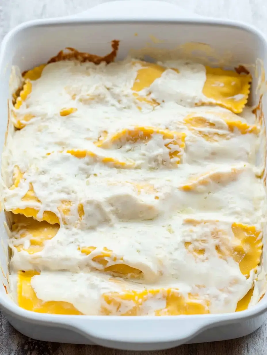 Million Dollar Ravioli Casserole 7 layered-ravioli-with-white-sauce-in-baking-dish