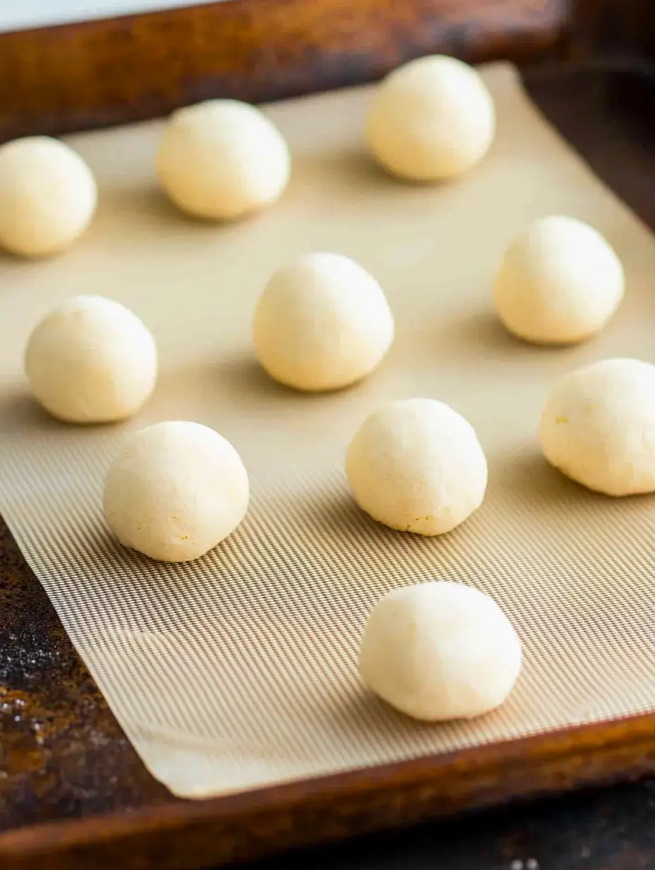 Raspberry Shortbread Cookies 6 raw-cookie-dough-formed-into-small-round-shapes-on-baking-sheet