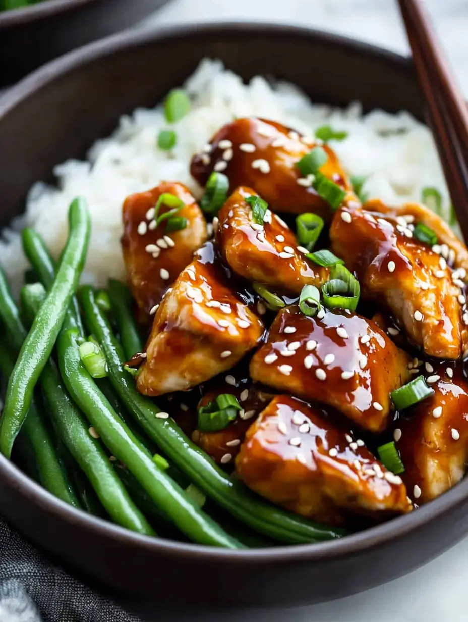 close-up-of-air-fryer-teriyaki-chicken-garnished-with-sesame-seeds-and-green-onions
