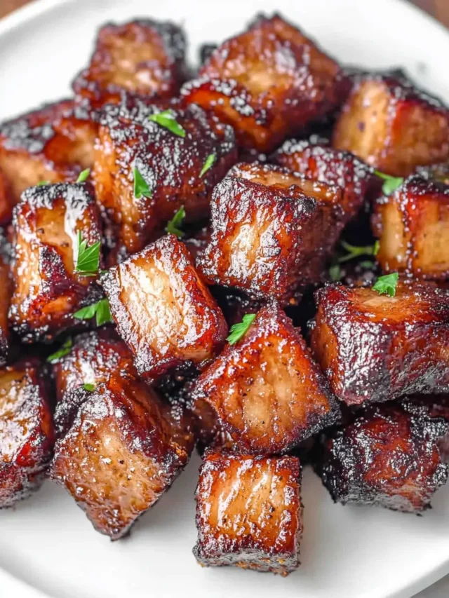 glazed-pork-belly-bites-in-a-white-plate-close-up