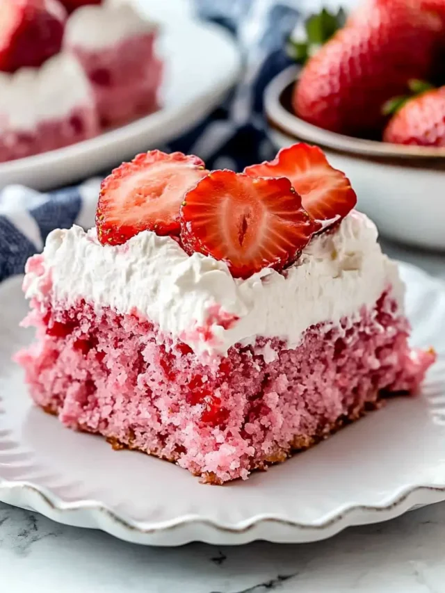 Strawberry-tres-leches-cake-slice-topped-with-whipped-cream-and-strawberries