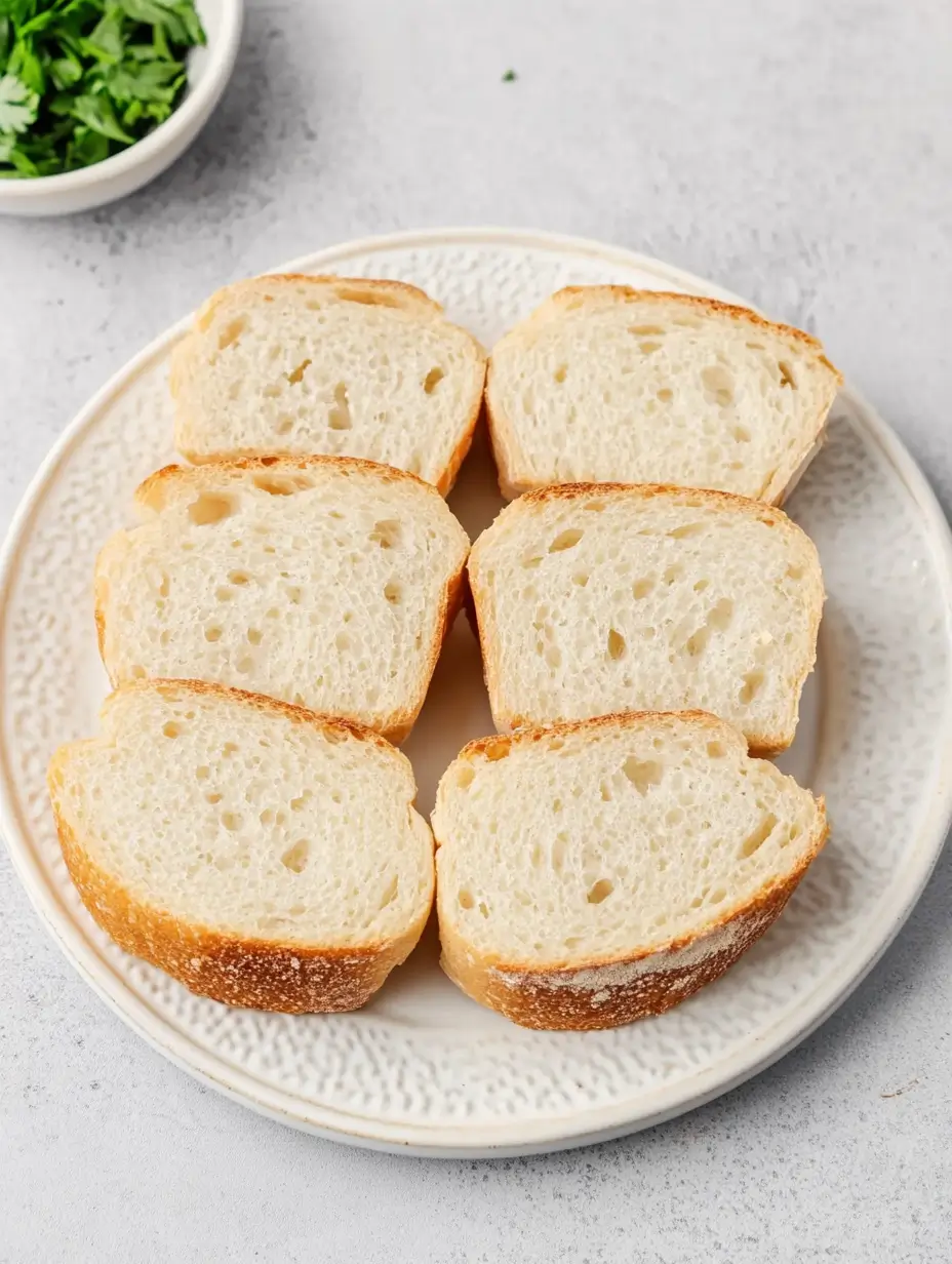 Irresistible Buttery Garlic Bread in Air Fryer 12 plain-bread-slices-on-plate-ready-for-preparation