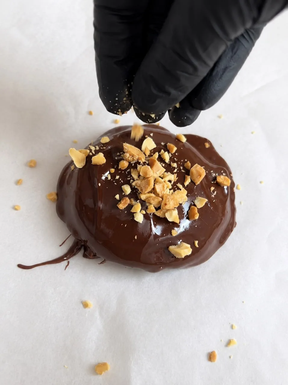 Chocolate Peanut Butter Yogurt Bites 11 sprinkling-chopped-peanuts-on-chocolate-coated-yogurt-bite