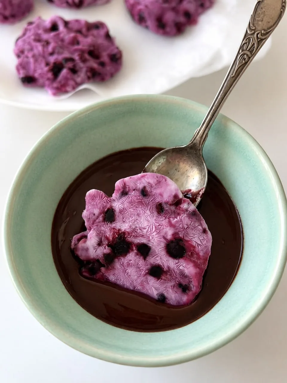 frozen blueberry cluster dipped in melted chocolate
