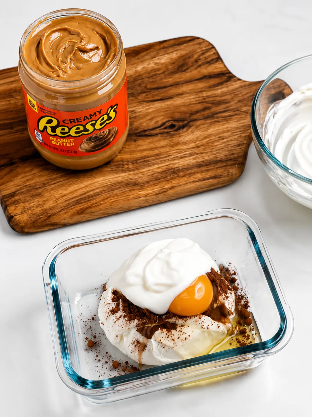 Protein Reese’s Cheesecake Recipe 2 Pouring blended Protein Reeses Cheesecake batter into a greased ramekin