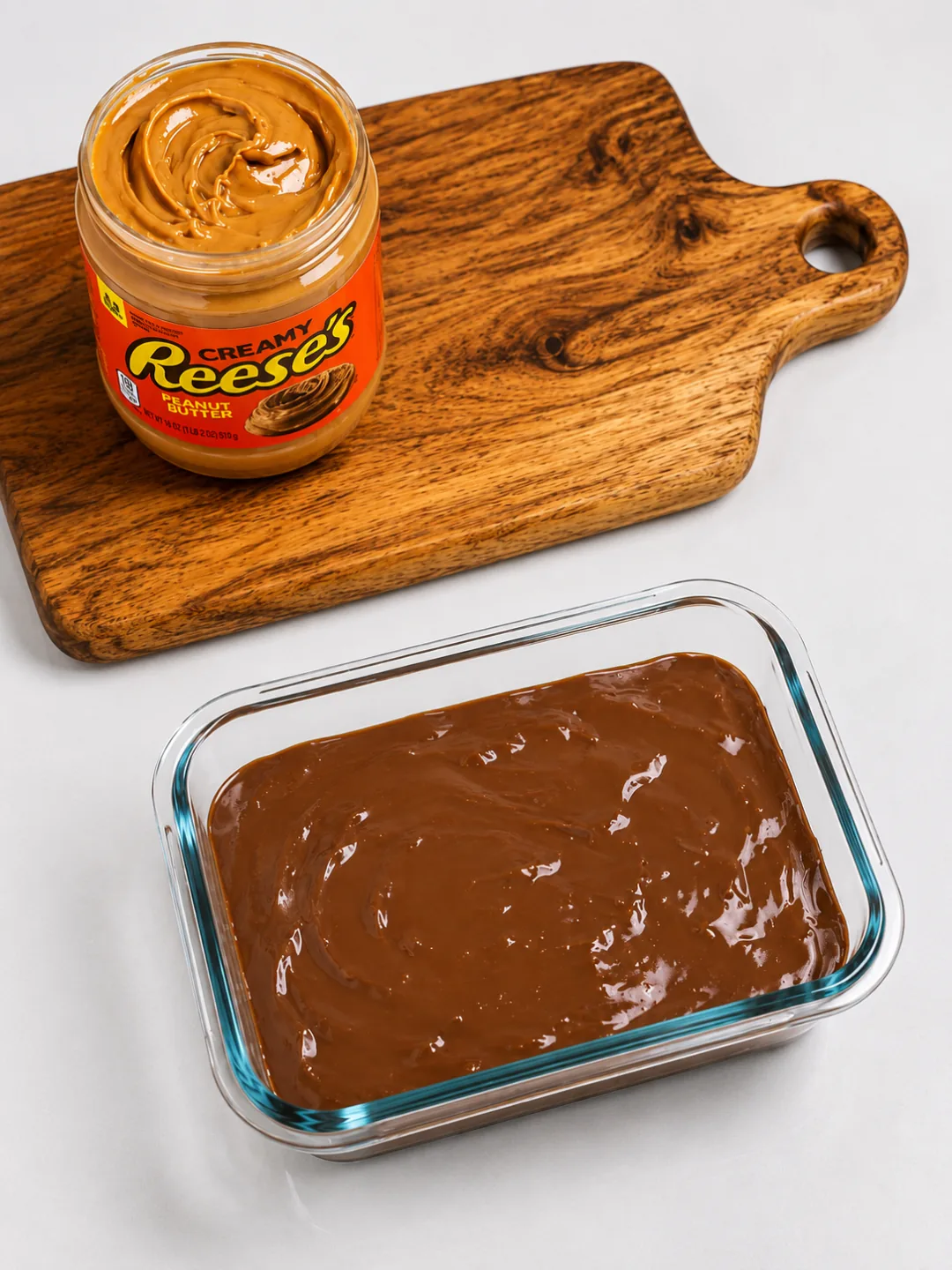 Protein Reese’s Cheesecake Recipe 3 Swirling peanut butter on top of Protein Reeses Cheesecake batter before baking