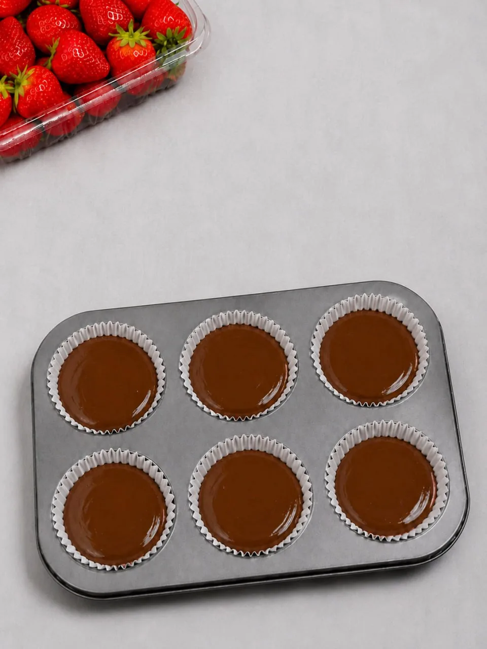 melted-chocolate-layer-in-lined-muffin-tin