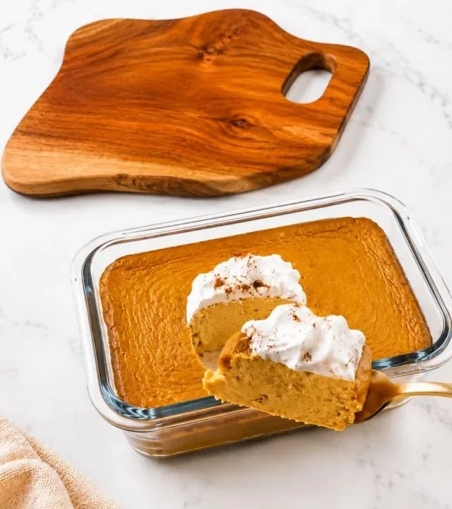 pumpkin-pie-cheesecake-slice-lifted-on-a-gold-spoon